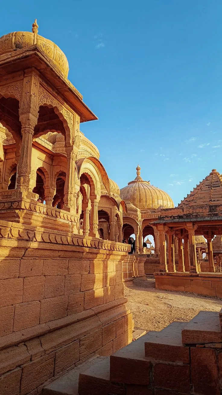Sandstone chhatris of Bada Bagh silhouetted in late afternoon light