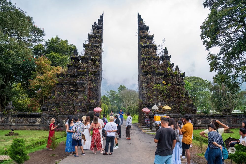 Visitors at an iconic Balinese temple gateway