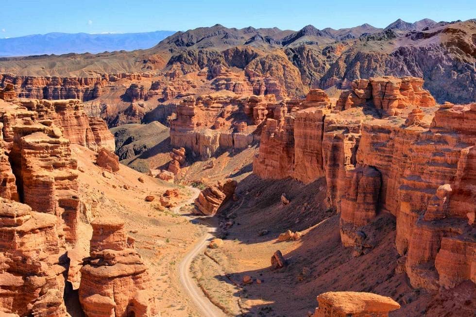 The eroded red rock formations of the Valley of Castles at Charyn Canyon under a clear sky